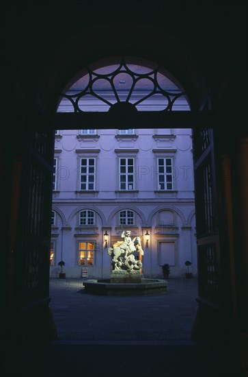 SLOVAKIA, Bratislava, Primacialny or Primate’s Palace.  Inner arcaded courtyard with fountain with statue of St George and the dragon at its centre framed by archway.