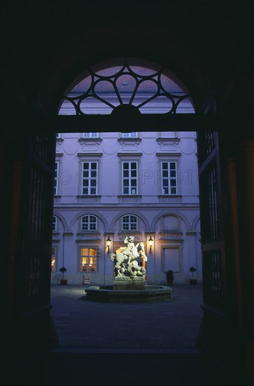 SLOVAKIA, Bratislava, Primacialny or Primate’s Palace. Inner arcaded courtyard with fountain with statue of St George and the dragon at its centre framed by archway.