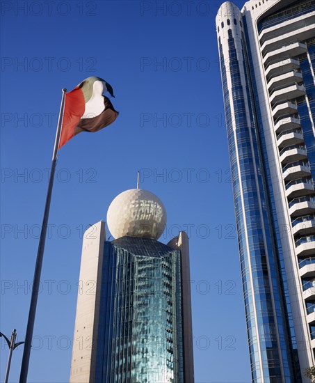 UAE, Dubai, Deira, Etisalat Building on Dubai Creek with flag pole in foreground.