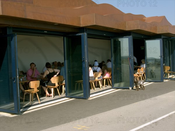 ENGLAND, West Sussex, Littlehampton, Customers sitting at tables inside the East Beach Cafe designed by Thomas Heatherwick