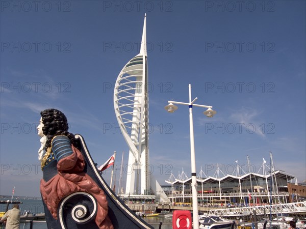 ENGLAND, Hampshire, Portsmouth, Gunwharf Quays. The Spinnaker Tower with figurehead in the foreground