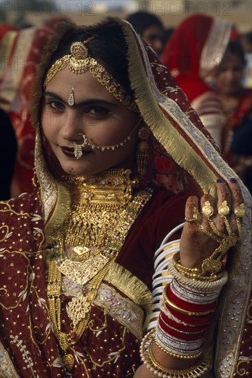 INDIA, Rajasthan, Jaisalmer, Portrait of a Miss Desert contestant wearing traditional jewellery at the Desert Festival