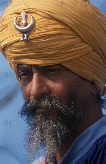 INDIA, Punjab, Kila Raipur, Portrait of Nihang a member of the Sikh Warrior caste wearing his ceremonial turban at the Rural Sports Festival
