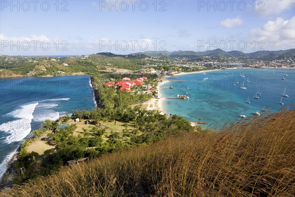 WEST INDIES, St Lucia, Gros Islet , The isthmus leading to Pigeon Island seen from Signal Hill within the National Historic Park with the Atlantic Ocean on the left and the Caribbean of Rodney Bay on the right