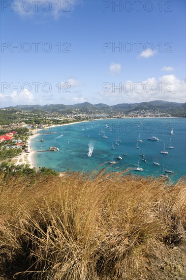 WEST INDIES, St Lucia, Gros Islet , Beach lined Rodney Bay with yachts at anchor seen from Signal Hill on Pigeon Island National Historic Park