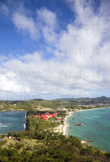 WEST INDIES, St Lucia, Gros Islet , The isthmus leading to Pigeon Island seen from Signal Hill within the National Historic Park with the Atlantic Ocean on the left and the Caribbean of Rodney Bay on the right
