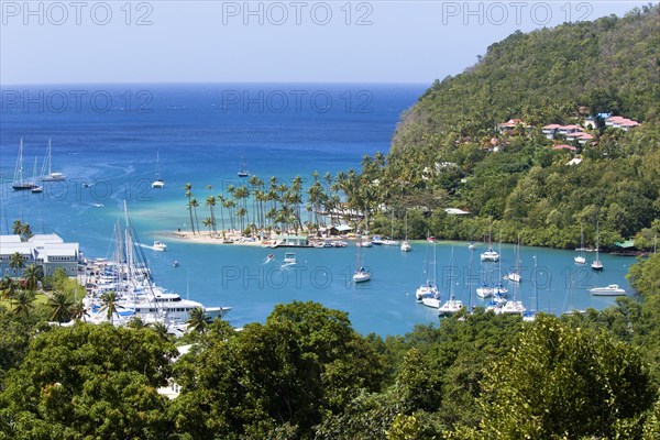 WEST INDIES, St Lucia, Castries , Marigot Bay The harbour with yachts at anchor the and lush surrounding valley. The small coconut palm tree lined beach of the Marigot Beach Club sits at the entrance to the harbour