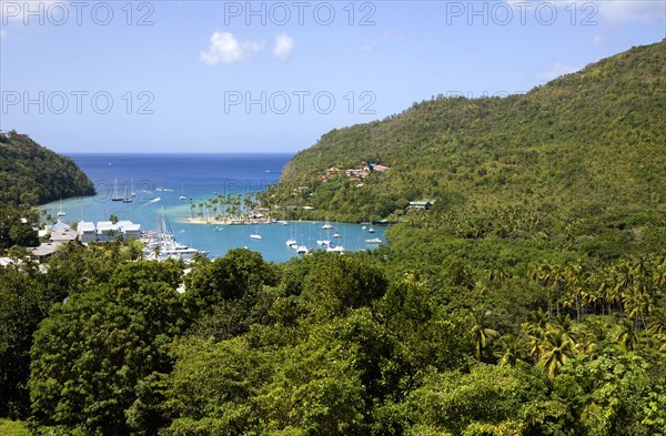 WEST INDIES, St Lucia, Castries, Marigot Bay with boats at anchor in the harbour below lush hillside vegetation