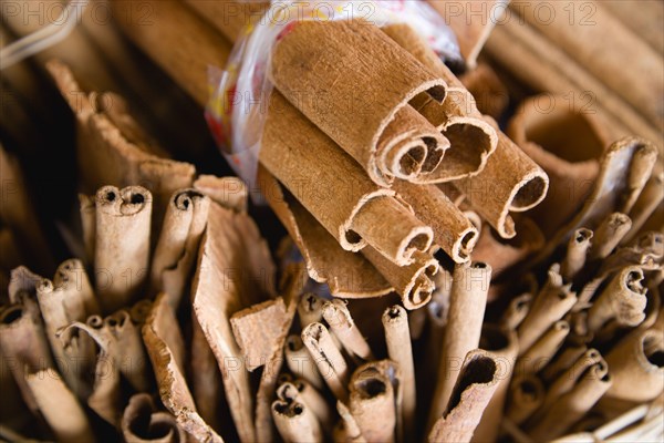 WEST INDIES, St Lucia, Castries, Market spice stall with cinnamon or cassia bark herbs tied in bundles