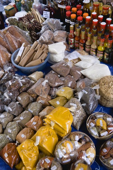 WEST INDIES, St Lucia, Castries, "Market stall with packets of locally produced herbs, spices and bottles of sauces"