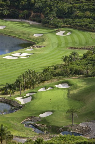 WEST INDIES, St Vincent & The Grenadines, Canouan, Raffles Resort Trump International Golf Course designed by Jim Fazio. The 16th green which is the longest par 3 in the world and the 17th fairway