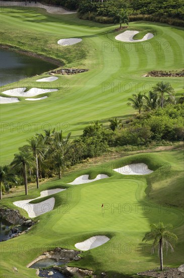WEST INDIES, St Vincent & The Grenadines, Canouan, Raffles Resort Trump International Golf Course designed by Jim Fazio. The 16th green which is the longest par 3 in the world and the 17th fairway