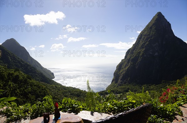WEST INDIES, St Lucia, Soufriere , Val des Pitons View from Ladera Spa Resort Hotel overlooking the lush valley and volcanic plugs of Gros Piton on the left and Petit Piton on the right with Jalousie beach between the mountains