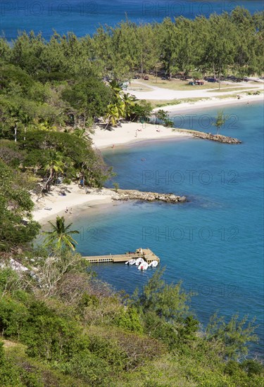 WEST INDIES, St Lucia, Gros Islet , Pigeon Island National Historic Park Small crescent shaped beaches and a wooden jetty set amongst coconut palms and casuarina trees