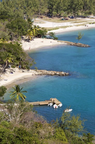 WEST INDIES, St Lucia, Gros Islet , Pigeon Island National Historic Park Small crescent shaped beaches and a wooden jetty set amongst coconut palms and casuarina trees