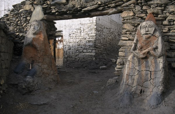 NEPAL, Annapurna Circuit Trek, Male and female Animistic protector guardians by the entrance gateway to Jharkot.