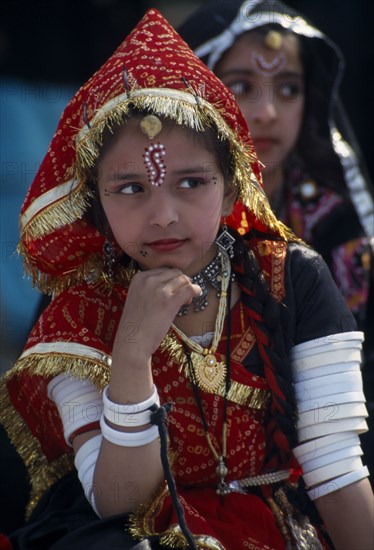 INDIA, Rajasthan, Alwar, Young girl dancer wearing traditional jewellery at the Alwar Utsav Festival
