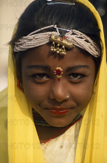 INDIA, Rajasthan, Alwar, Head and shoulders portrait of a young girl dancer at the Alwar Utsav Festival