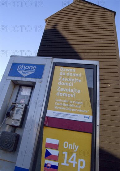 ENGLAND, East Sussex, Hastings, A public telephone kiosk advertising cheap calls to Eastern European countries