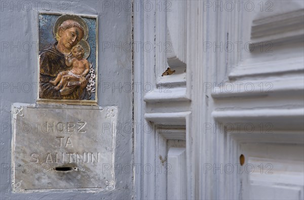 MALTA, Valletta, Collection box for Saint Anthony in a doorway on Republic Street with a small painting of the saint above