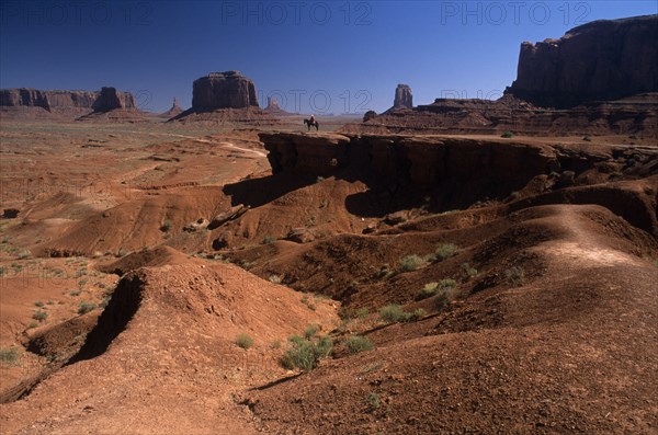 USA, Arizona , Monument Valley, "John Ford Point on Valley Drive with lone figure on horseback overlooking mesas, buttes and desert floor."