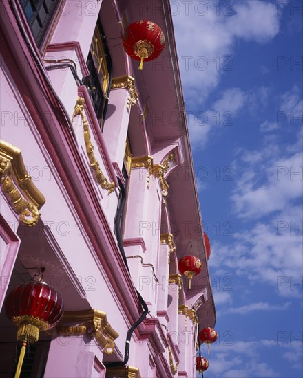 MALAYSIA, Penang, Georgetown, Pink and gold painted shopfront hung with red and gold Chinese lanterns for Chinese New Year.