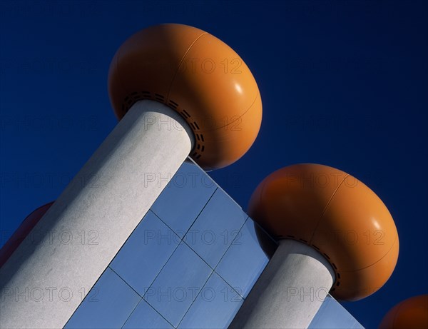 HOLLAND, Noord Holland, Zandvoort, The Circus Building amusement arcade and cinema complex. Detail of modern roof with doughnut shaped orange rings against a blue sky