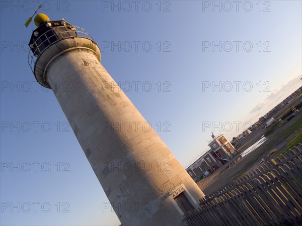 ENGLAND, West Sussex, Shoreham-by-Sea, Angled view of the Lighthouse at Kingston Beach next to Shoreham Harbour in evening light