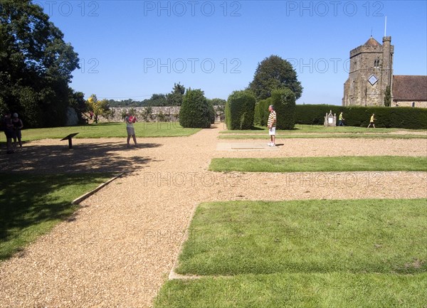 ENGLAND, East Sussex, Battle, Battle Abbey. Visitors in grounds of partially ruined abbey complex near to the spot that King Harold fell in the 1066 Battle of Hastings