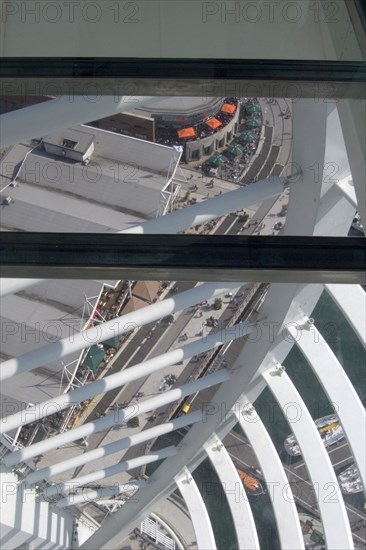 ENGLAND, Hampshire, Portsmouth, Gunwharf Quays. The Spinnaker Tower. Interior view looking down from observation deck through glass window towards the base of the tower over waterfront restaurants and shops.