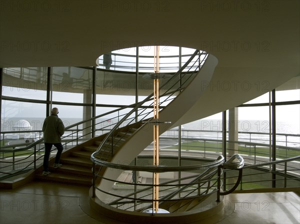 ENGLAND, East Sussex, Bexhill-on-Sea, The De La Warr Pavilion. Interior view of the helix staircase with visitors walking the steps