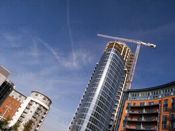 ENGLAND, Hampshire, Portsmouth, Gunwharf Quays complex. A development of tall modern apartments in process of being built. Angled view.