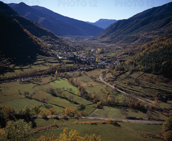 SPAIN, Aragon, Huesca, Village of Broto on valley floor and surrounding landscape in Autumn colours.