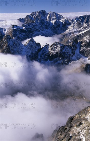 SLOVAKIA, Carpathian Mtns, High Tatras Mtns, View over snowy peaks of the High Tatras mountains above drifting cloud from the Lomnicky Stit viewpoint.