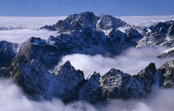 SLOVAKIA, Carpathian Mtns, High Tatras Mtns, View over snowy peaks of the High Tatras mountains above drifting cloud from the Lomnicky Stit viewpoint.