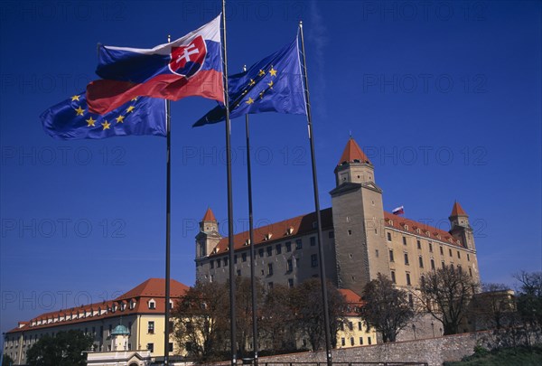 SLOVAKIA, Bratislava, "Flags flying outside Bratislava Castle, reconstructed 1956-68 after burning down.  Part of the compound continues to be used by the Slovak Parliament."