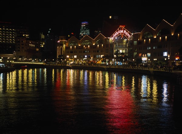 SINGAPORE, Clarke Quay, Lights from quayside shops and restaurants reflected in the Singapore River at night.