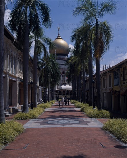 SINGAPORE, Kampong Glam , Sultan Mosque, "Paved, palm lined road leading to the Sultan Mosque on North Bridge Road with four minarets and large gold dome.  Family approaching entrance."