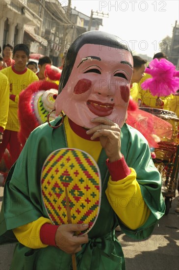 THAILAND, North, Chiang Mai, "Chinese New Year celebrations. Dwarf in parade, Warorot Market area Chiang Mai's China Town,"
