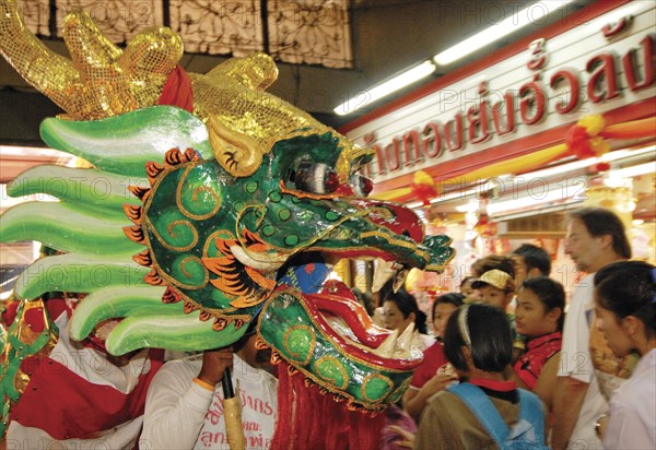 THAILAND, North, Chiang Mai, "Chinese New Year celebrations. Chinese dragon dancers inside Warorot Market, Chiang Mai's China Town"