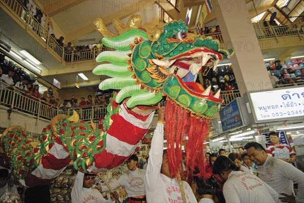 THAILAND, North, Chiang Mai, "Chinese New Year celebrations. Chinese dragon dancers inside Warorot Market, Chiang Mai's China Town"