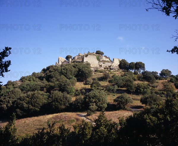 FRANCE, Languedoc-Roussillon, Aude, "Ruins of Chateau Termes, medieval Cathar stronghold on top of steep, tree covered hillside."