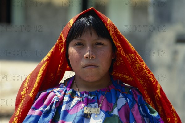 PANAMA, San Blas Islands, Kuna Indigenous Tribe, Portrait of young Kuna Indian girl wearing traditional gold nose ring with a black line drawn along length of nose