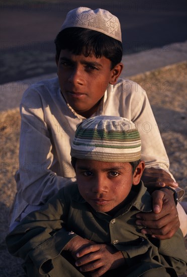INDIA, Madhya Pradesh, Bhopal, "Head and shoulders portrait of two, young Muslim boys."