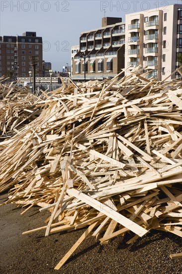 ENGLAND, West Sussex, Worthing, Timber washed up on the beach from the Greek registered Ice Princess which sank off the Dorset coast on 15th January 2008. Seafront flats beyond on the promenade