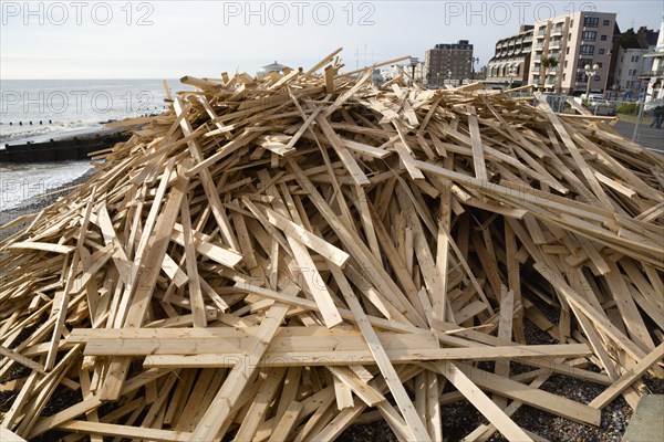 ENGLAND, West Sussex, Worthing, Timber washed up on the beach from the Greek registered Ice Princess which sank off the Dorset coast on 15th January 2008. Seafront flats beyond