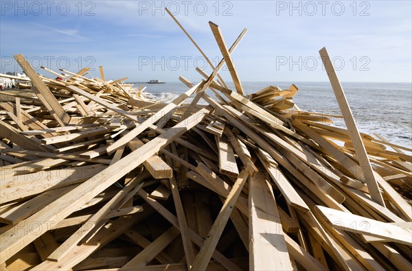 ENGLAND, West Sussex, Worthing, Timber washed up on the beach from the Greek registered Ice Princess which sank off the Dorset coast on 15th January 2008. Worthin Pier in the distance