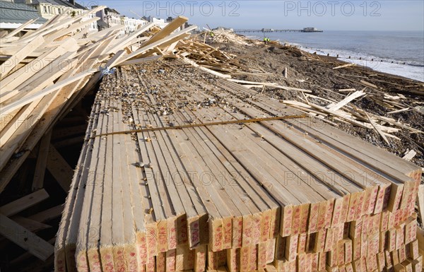 ENGLAND, West Sussex, Worthing, Timber washed up on the beach from the Greek registered Ice Princess which sank off the Dorset coast on 15th January 2008. Worthing Pier in the distance