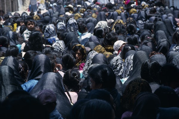 MEXICO, Oaxaca, "Crowds of women and children during Easter celebrations, many wearing black head coverings."