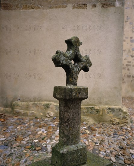 FRANCE, Languedoc-Roussillon, Aude, Fanjeaux.  Ancient stone cross outside the thirteenth century Eglise d’Notre Dame.  The village had associations with the Cathars.